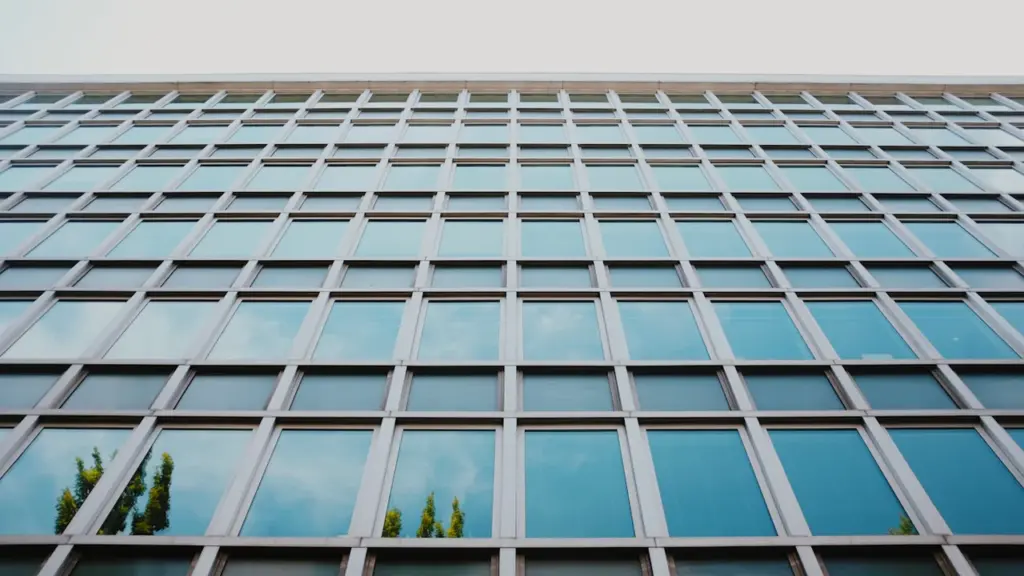 Šiuolaikinis stiklinis administracinis pastatas simbolizuojantis valstybinę instituciją ir skaidrią veiklą.
